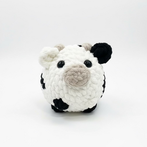 Crocheted panda toy on a white background